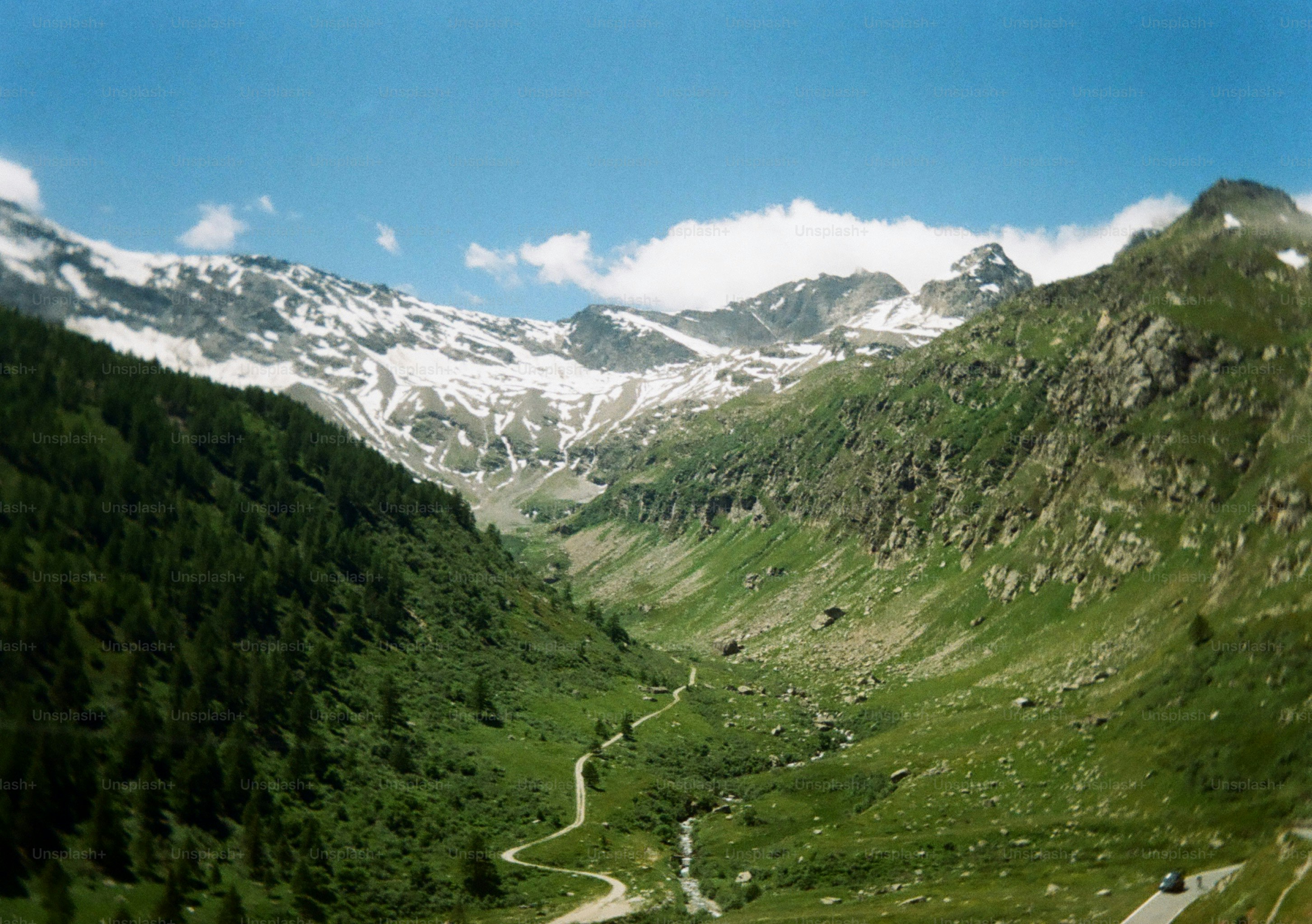 A winding road runs through a mountain valley.